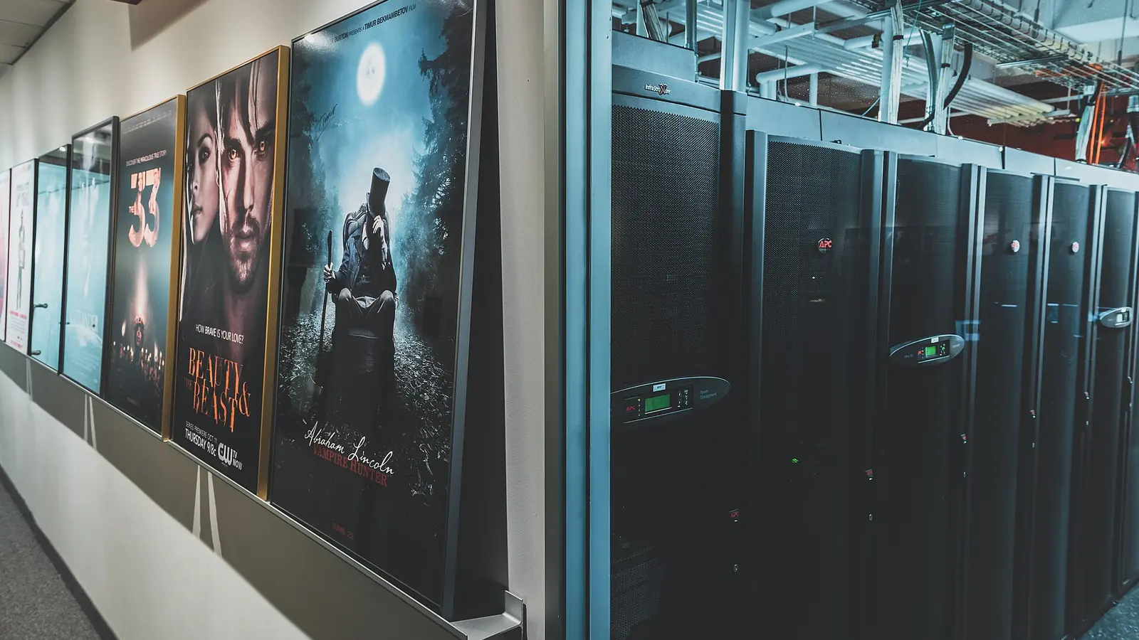A server aisle inside a data center, with processing equipment arranged in racks.